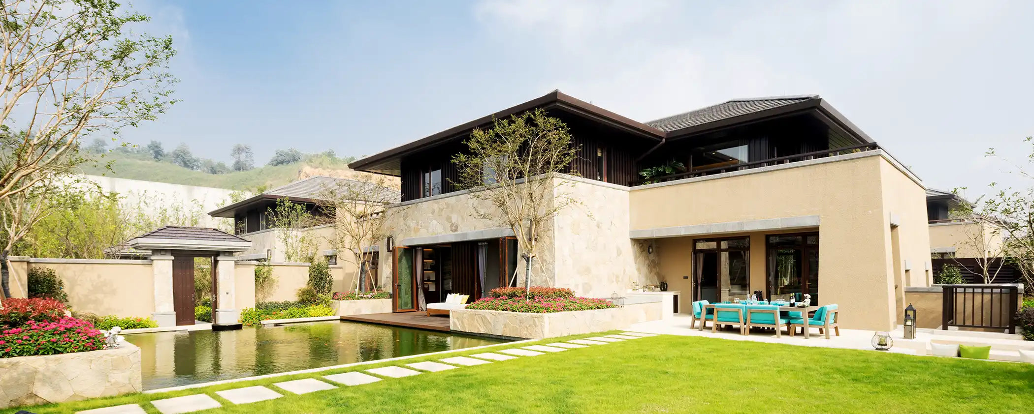 Modern house with a pool and garden using Natural Action Whole Home Water Solutions.